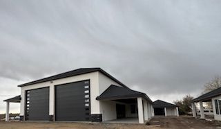 Empty garage interior with a white sectional door and plain white wall