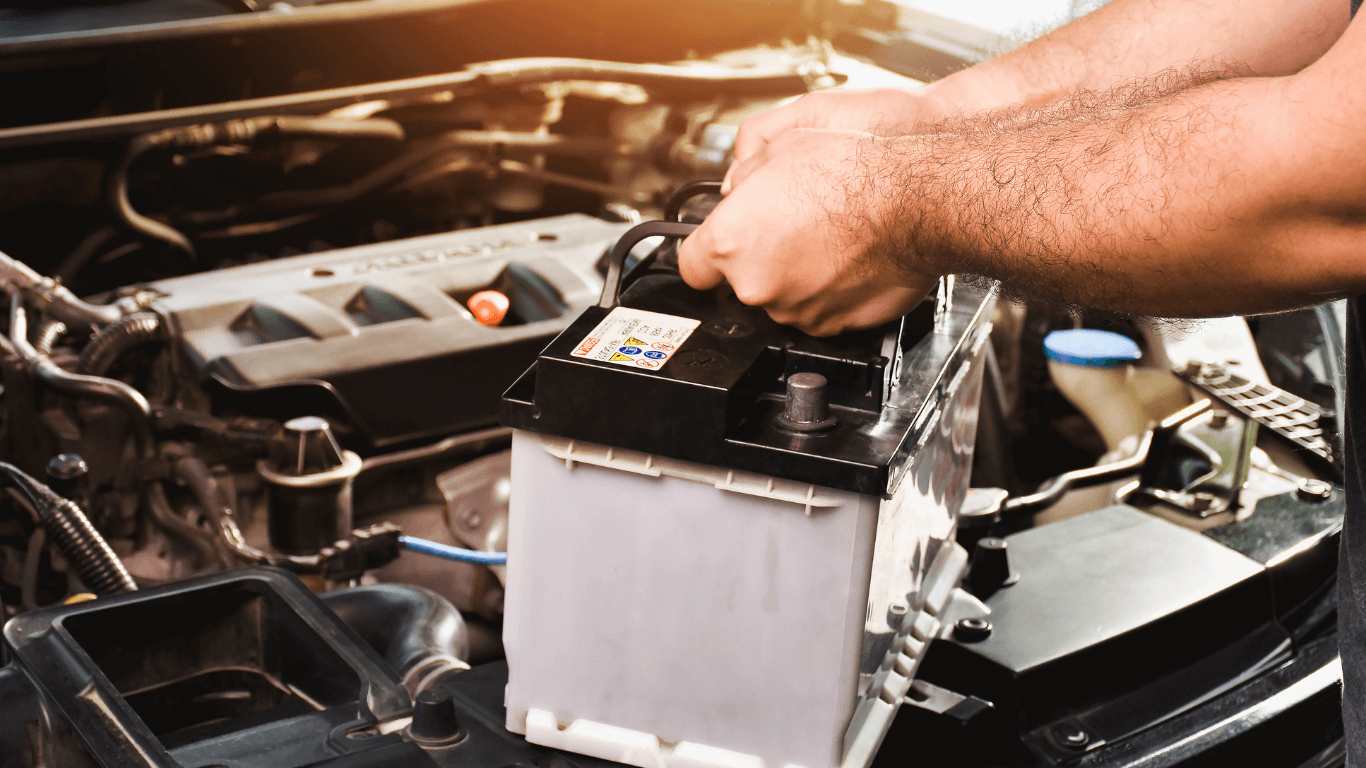 A mechanic changing a car battery