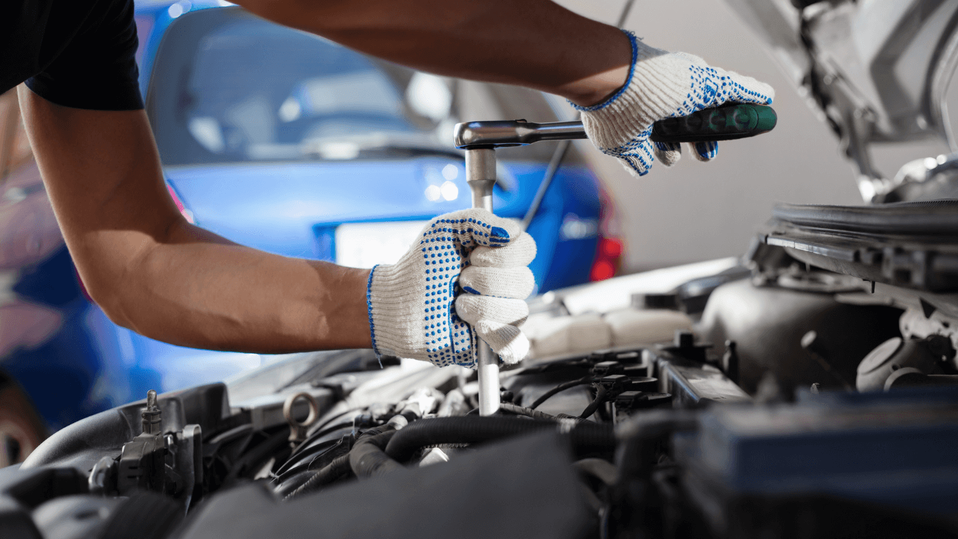 A mechanic performing an auto repair with tools