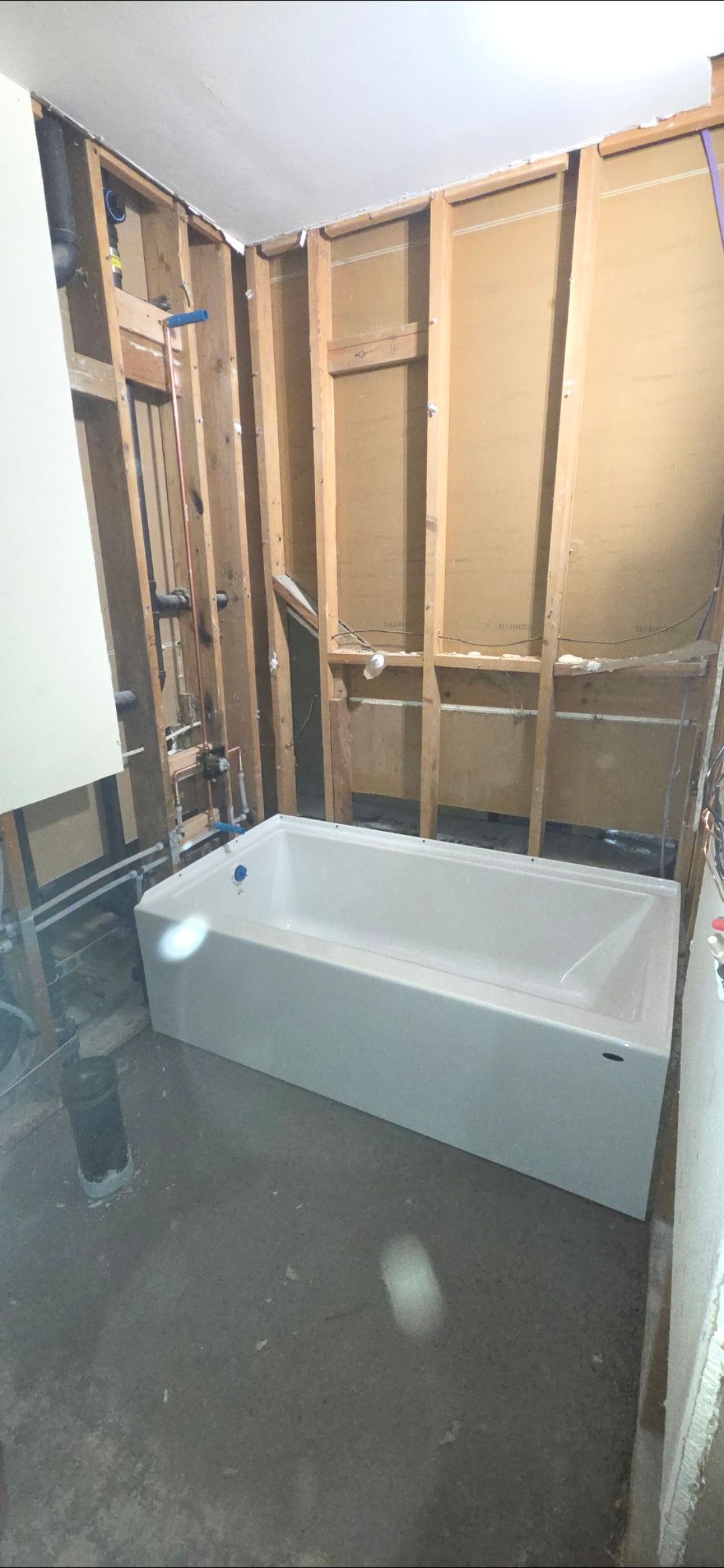 Bathroom vanity with wooden cabinets, white countertop, and silver faucet.