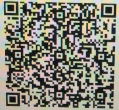 Blurry black-and-white QR code with a faint face-like pattern in the center