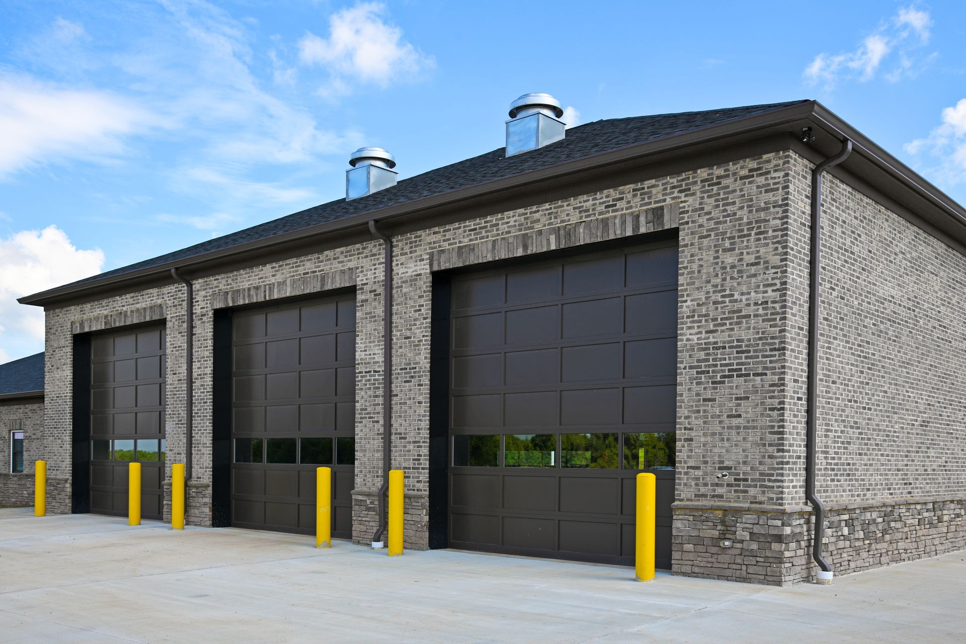 Open brick garage doorway with a dark empty interior Open brick garage doorway with a dark empty interior