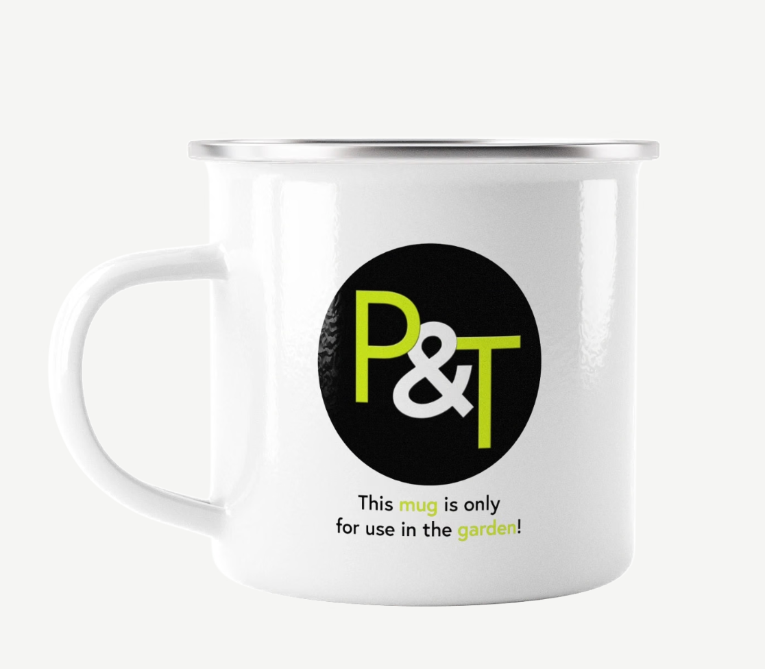 a white enamel mug on a white background with the Pots and Trowels logo P and T in green and white on a black circle
