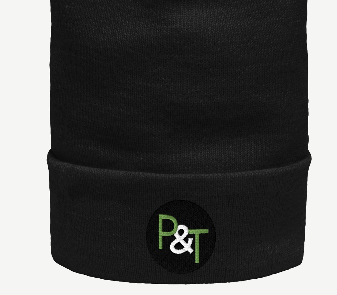 a black beanie hat on a white background with the Pots and Trowels logo P and T in green and white on a black circle