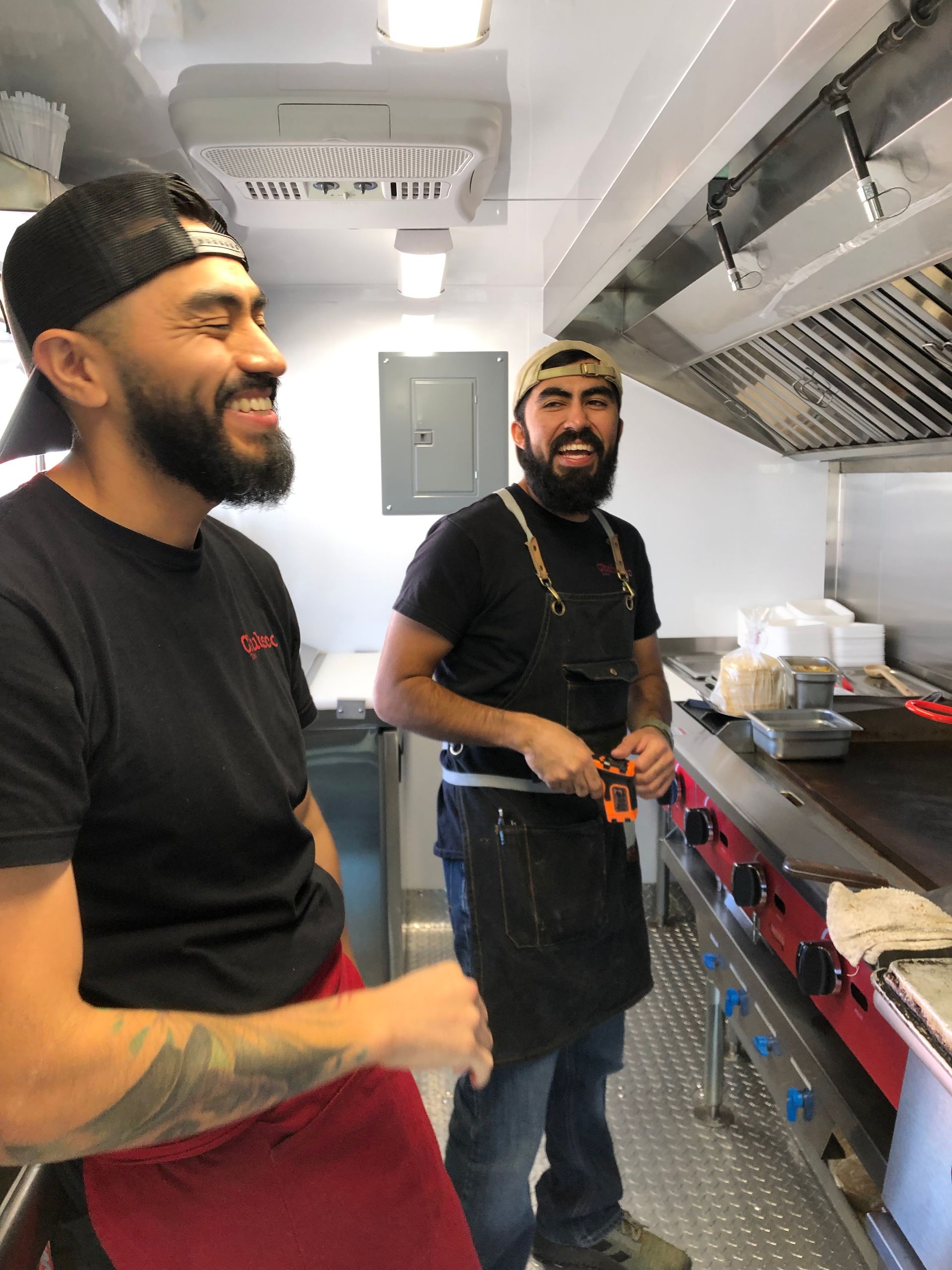 Chubasco Tacos team preparing Sonoran-style tacos and hot dogs in Phoenix kitchen
