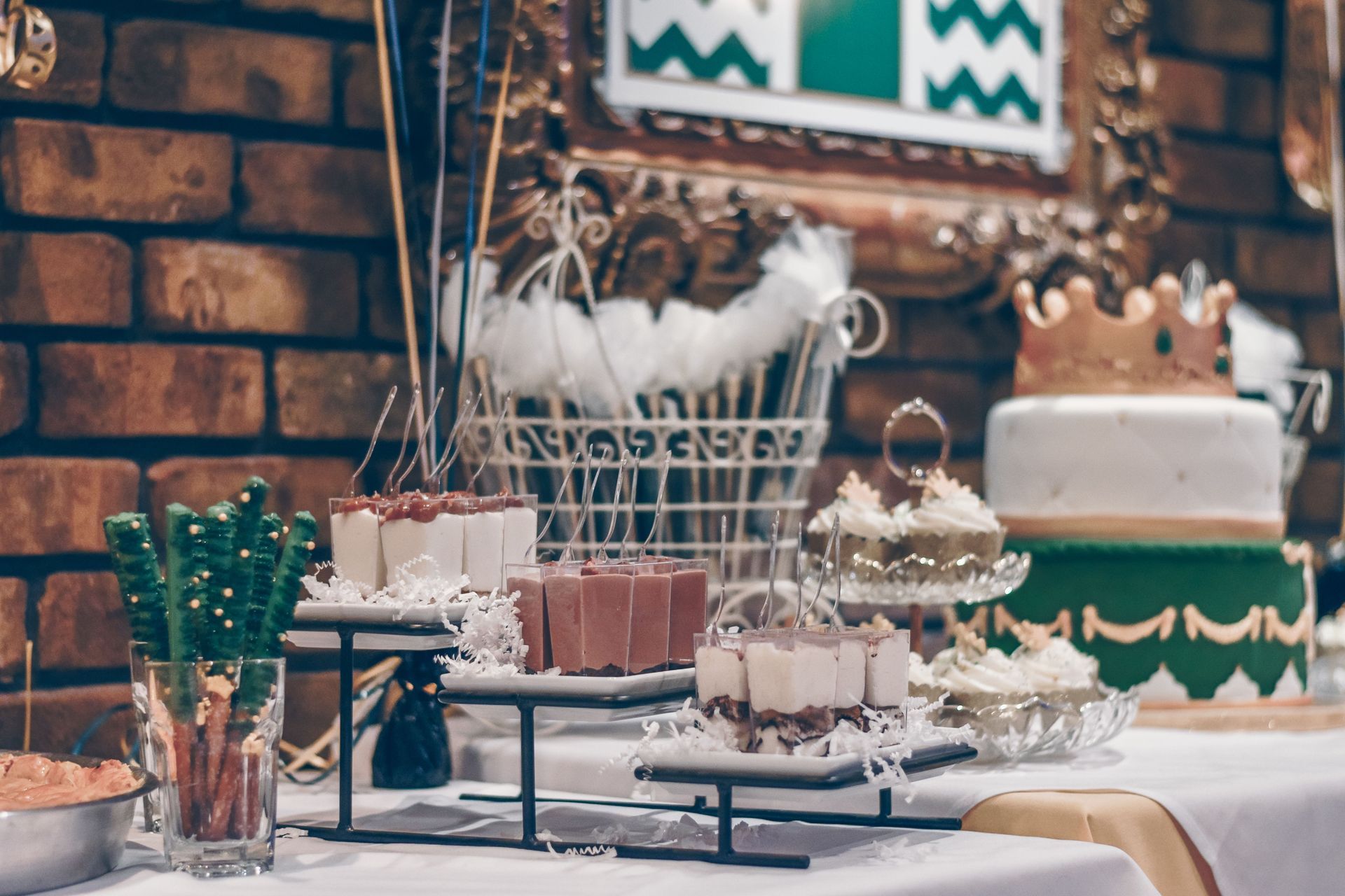 Dessert buffet with cakes, pastries, and decor on a table at a party