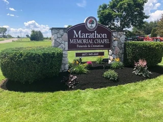 Marathon Memorial Chapel sign in landscaped lawn under a sunny blue sky