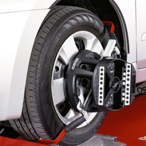 A car is being aligned with a machine that says sparco on it