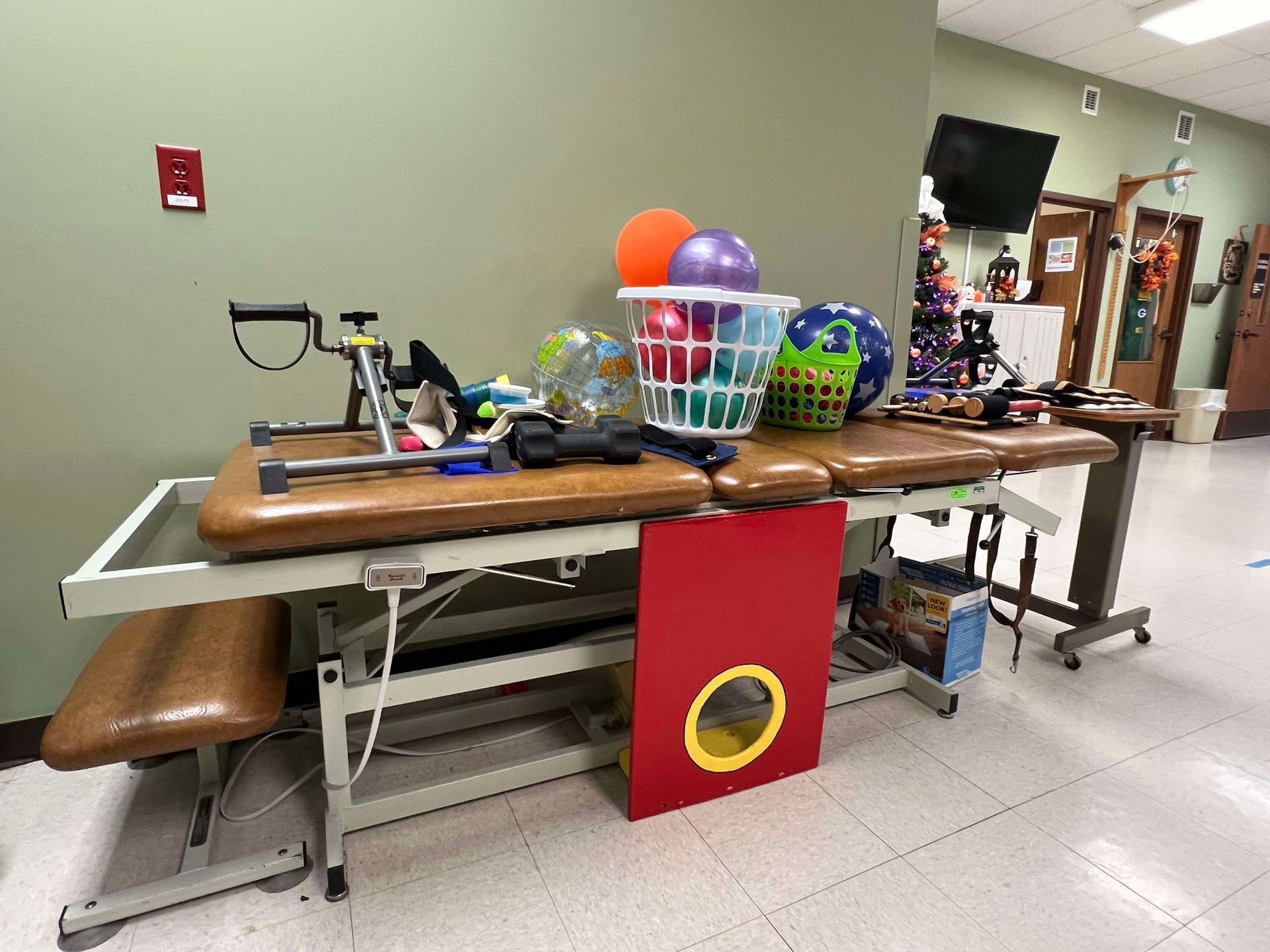 A bunch of balls are on a table in a room.