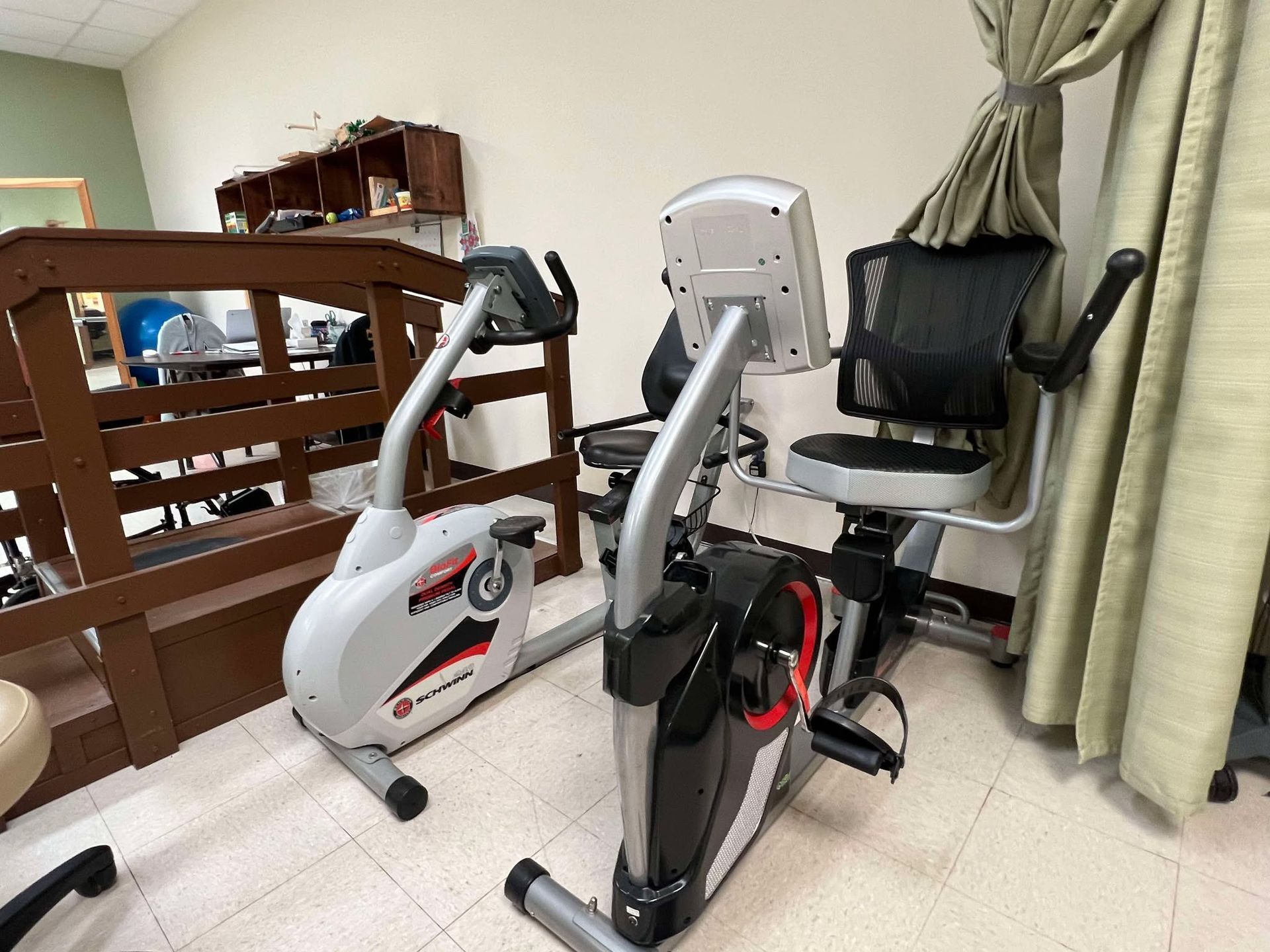 Two exercise bikes are sitting next to each other in a room.