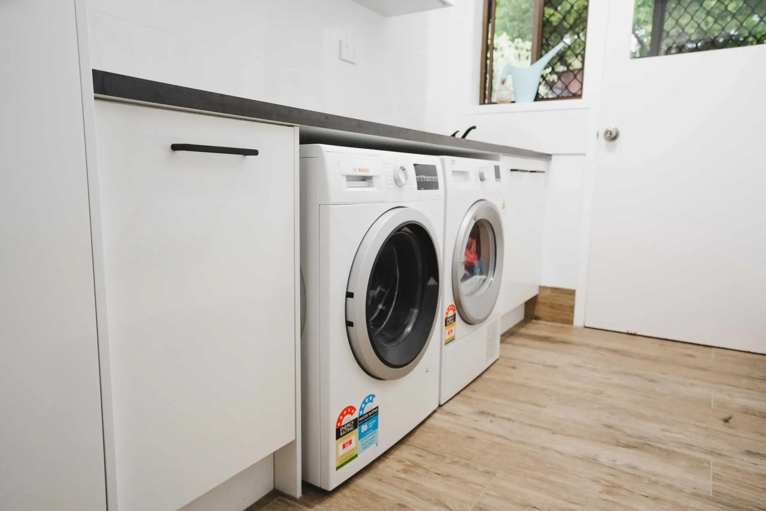 A Laundry Room With a Washing Machine and Dryer — CK Cabinetry in Coolum Beach, QLD