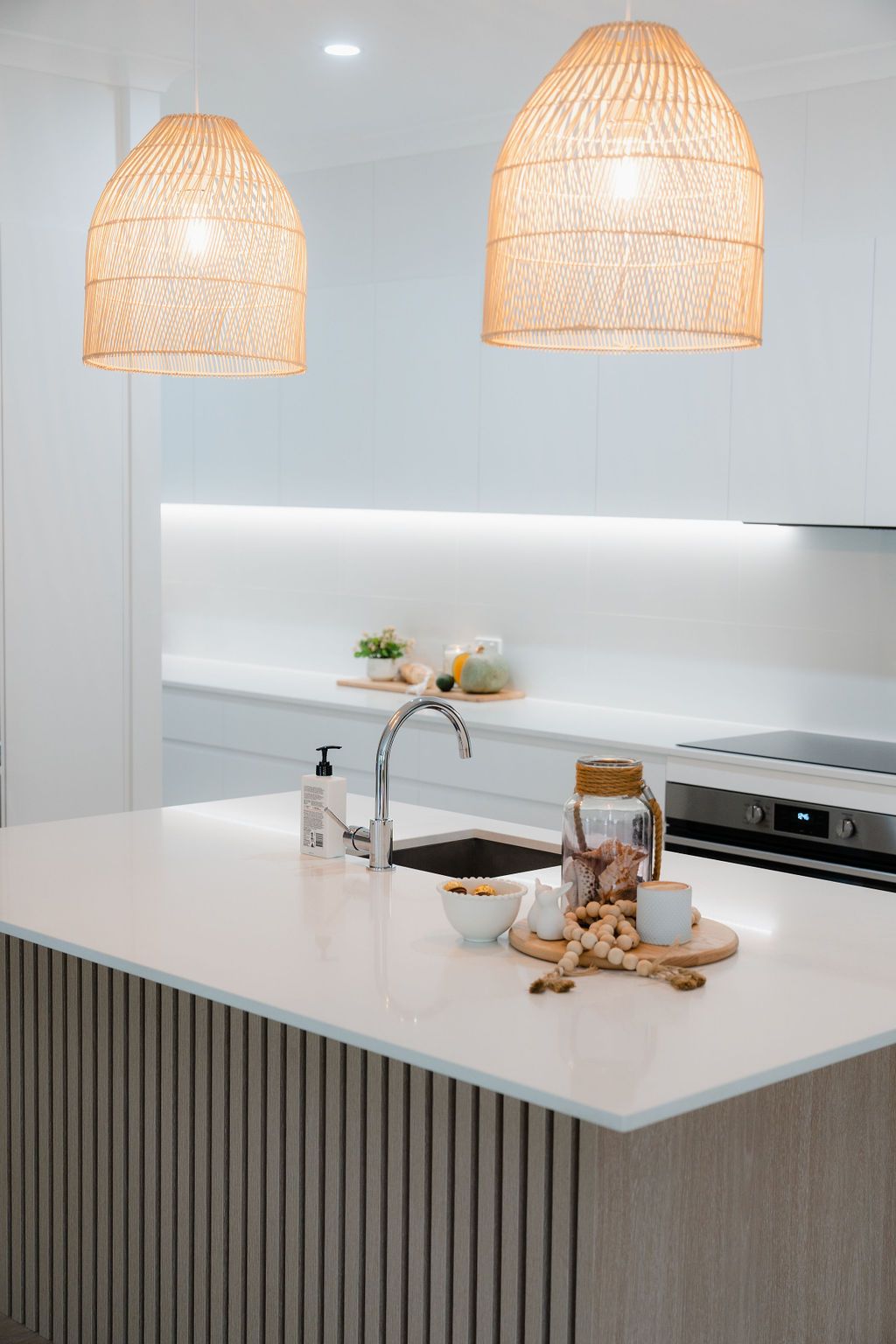 A Kitchen With White Cabinets and a Stove Top Oven — CK Cabinetry in Caloundra, QLD