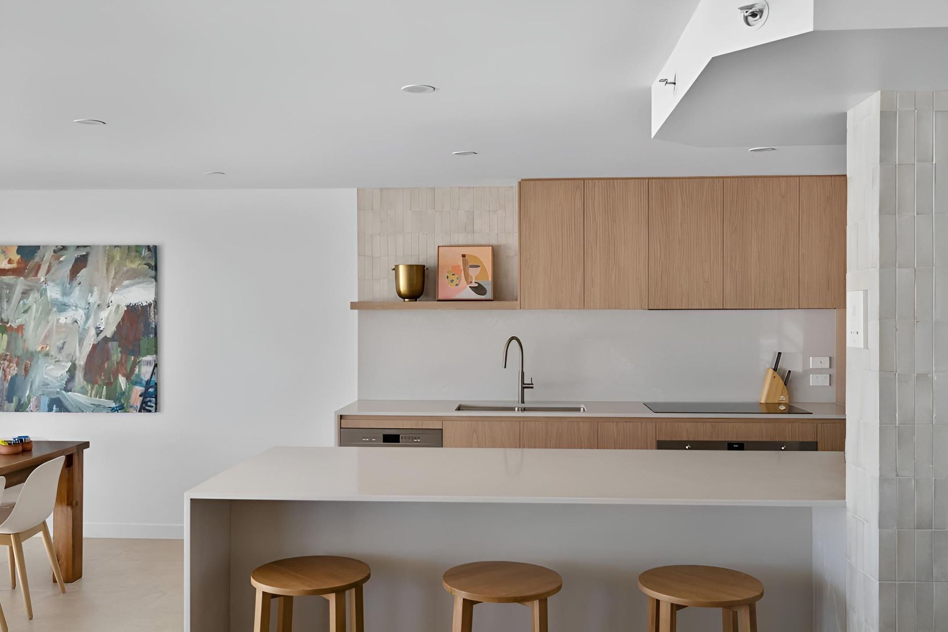 A Kitchen With Wooden Cabinets and Stools and a Painting on the Wall — CK Cabinetry in Maroochydore, QLD