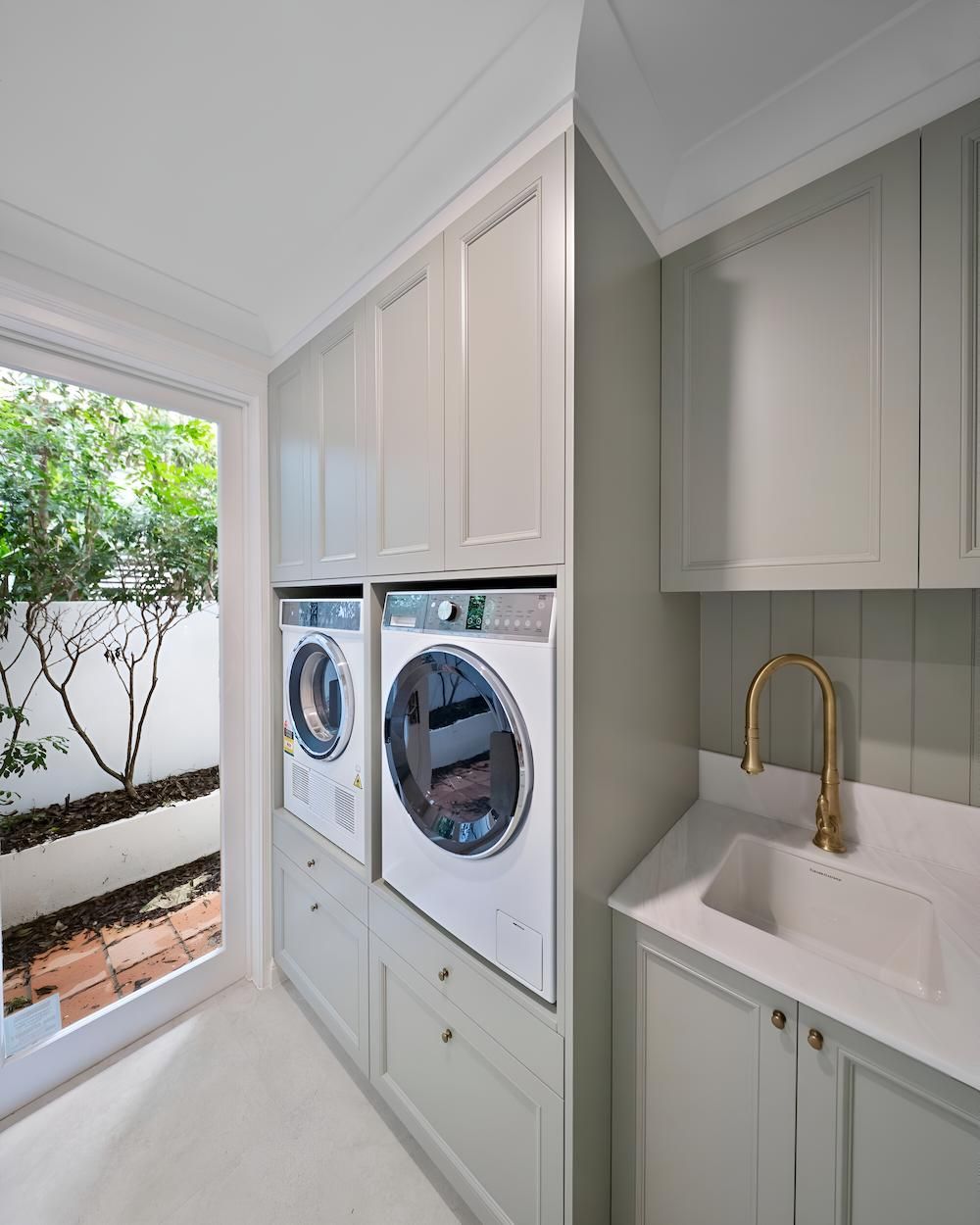 A Laundry Room With a Washer and Dryer and a Sink — CK Cabinetry in Coolum Beach, QLD