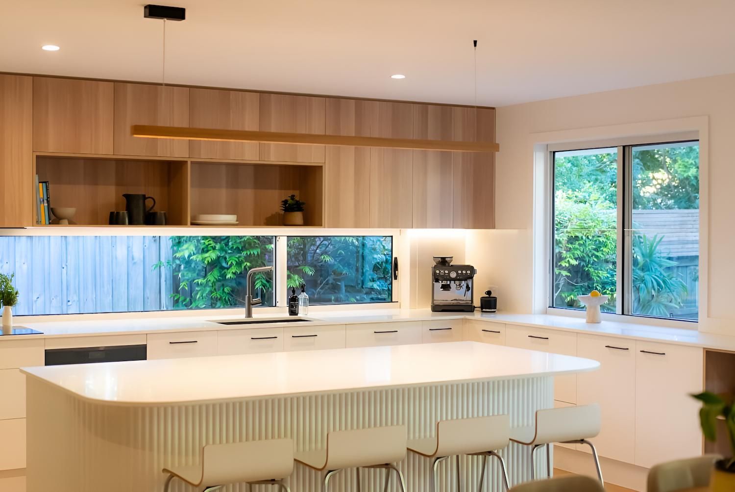 A Kitchen With White Cabinets and a Large Island in the Middle — CK Cabinetry in Coolum Beach, QLD