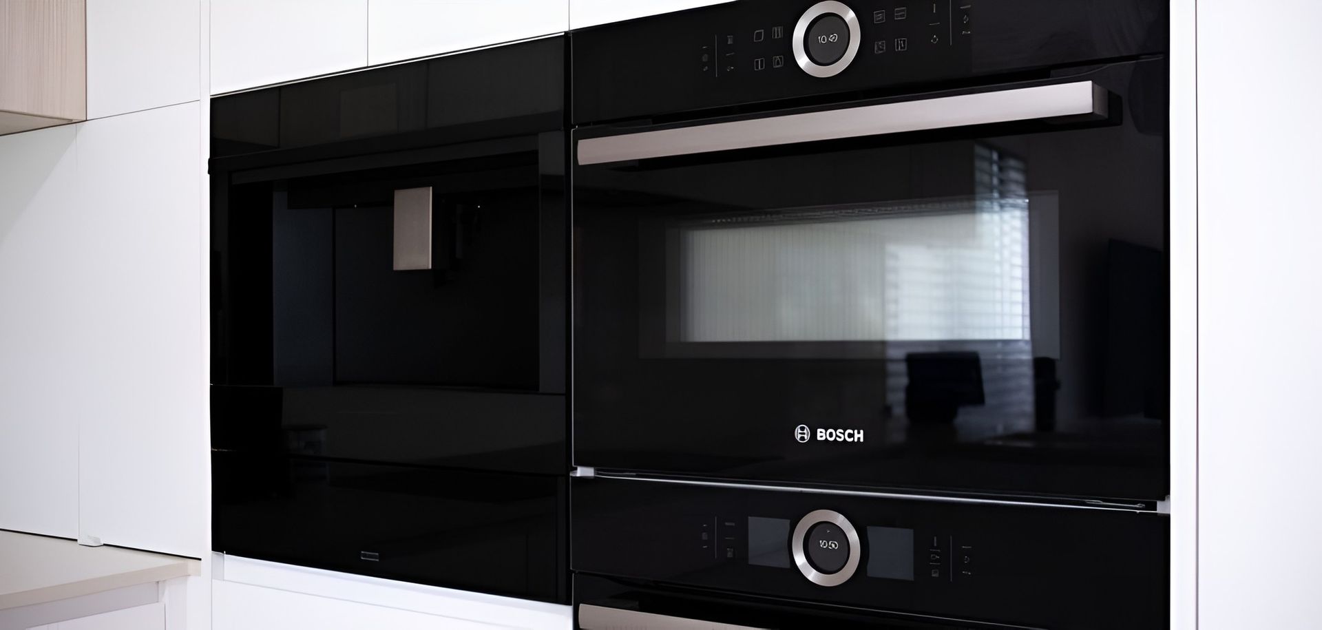 A Black Microwave Oven is Sitting in a Kitchen — CK Cabinetry in Coolum Beach, QLD