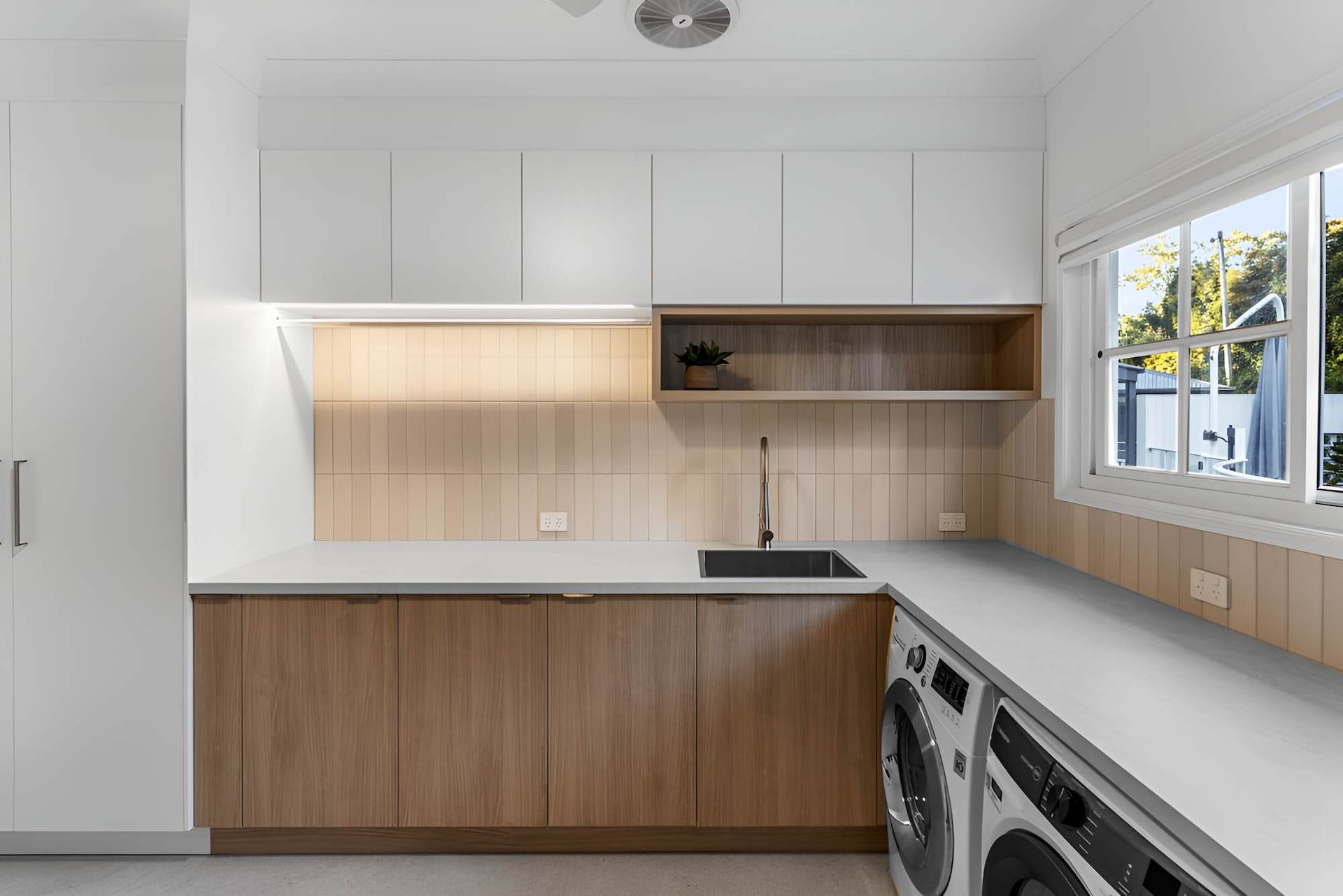 A Laundry Room With Wooden Cabinets, a Washer and Drye — CK Cabinetry in Coolum Beach, QLD