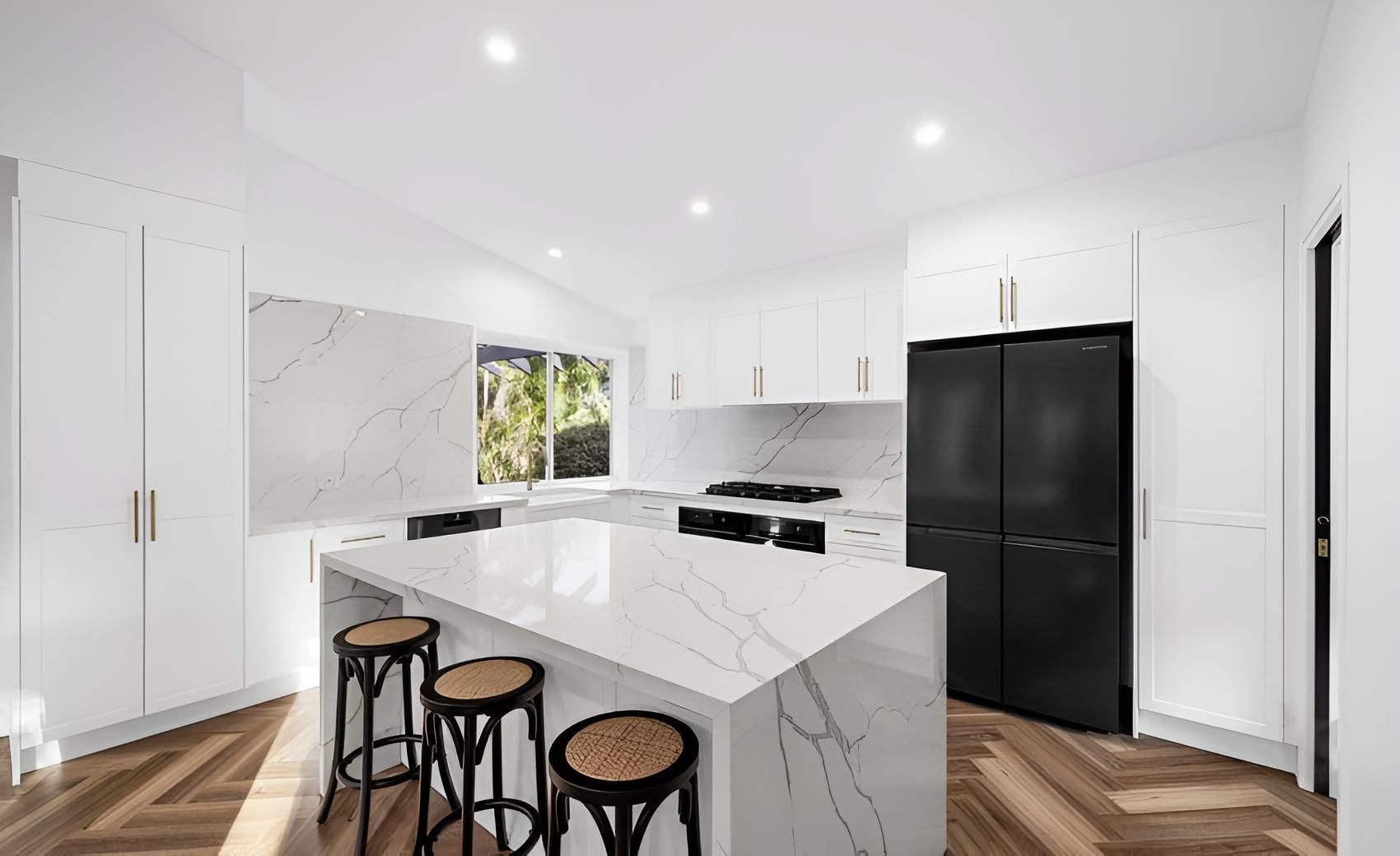 A Kitchen With White Cabinets , Black Appliances — CK Cabinetry in Coolum Beach, QLD