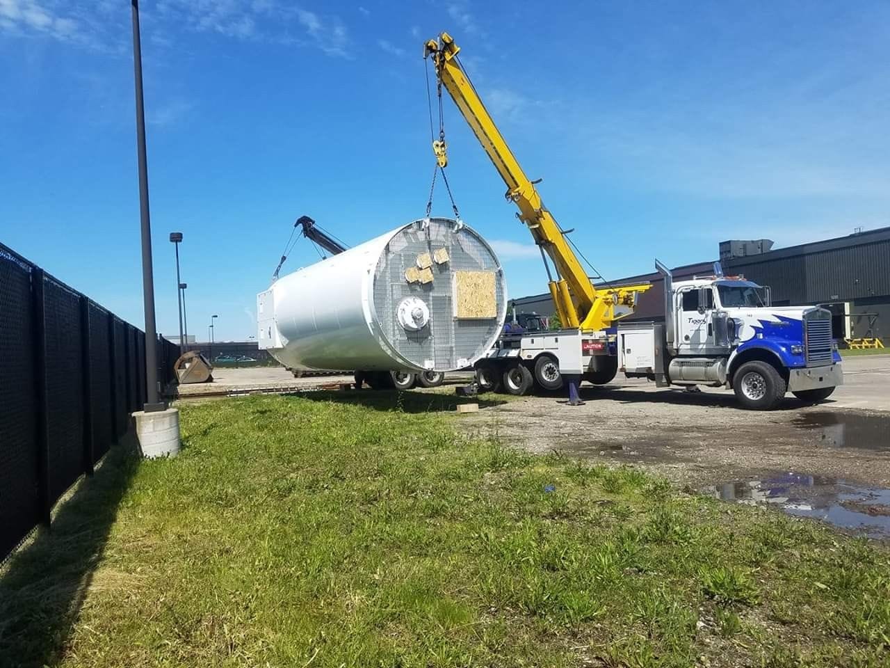 Tow Truck Lifting a Large Cylinder — Battle Creek, MI — Tiger’s Towing