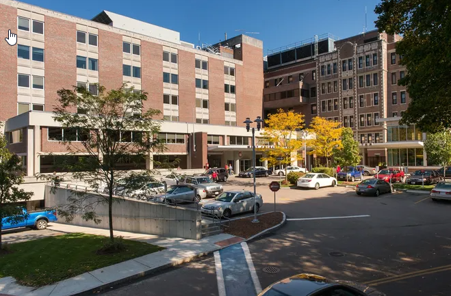 A large brick building with cars parked in front of it