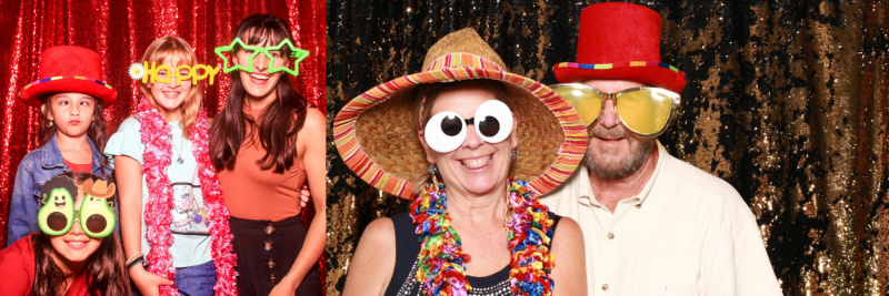 People posing in colorful party hats and novelty glasses against a glittery backdrop