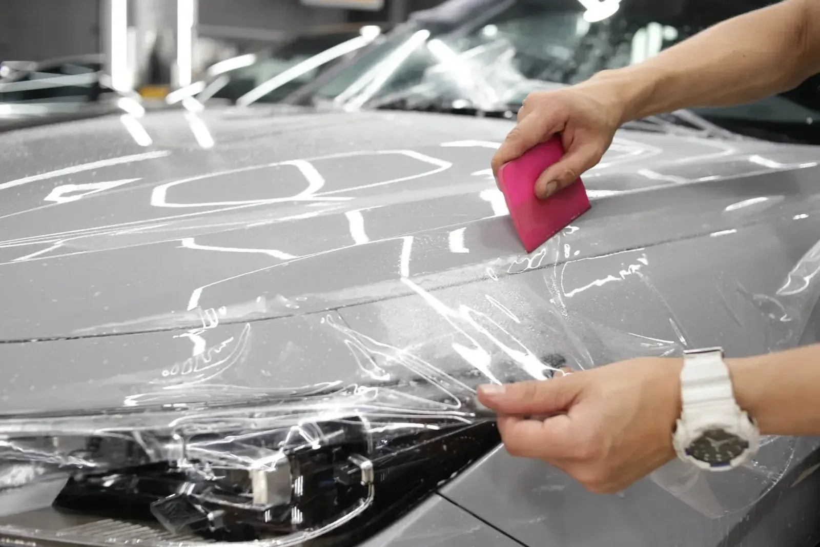 Paint protection film being installed on a car hood at Tidy Car in Sheboygan, Wisconsin