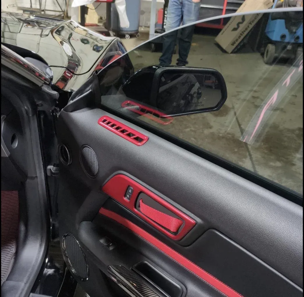 Tinted front side window on a car with the door open at Tidy Car in Sheboygan, Wisconsin