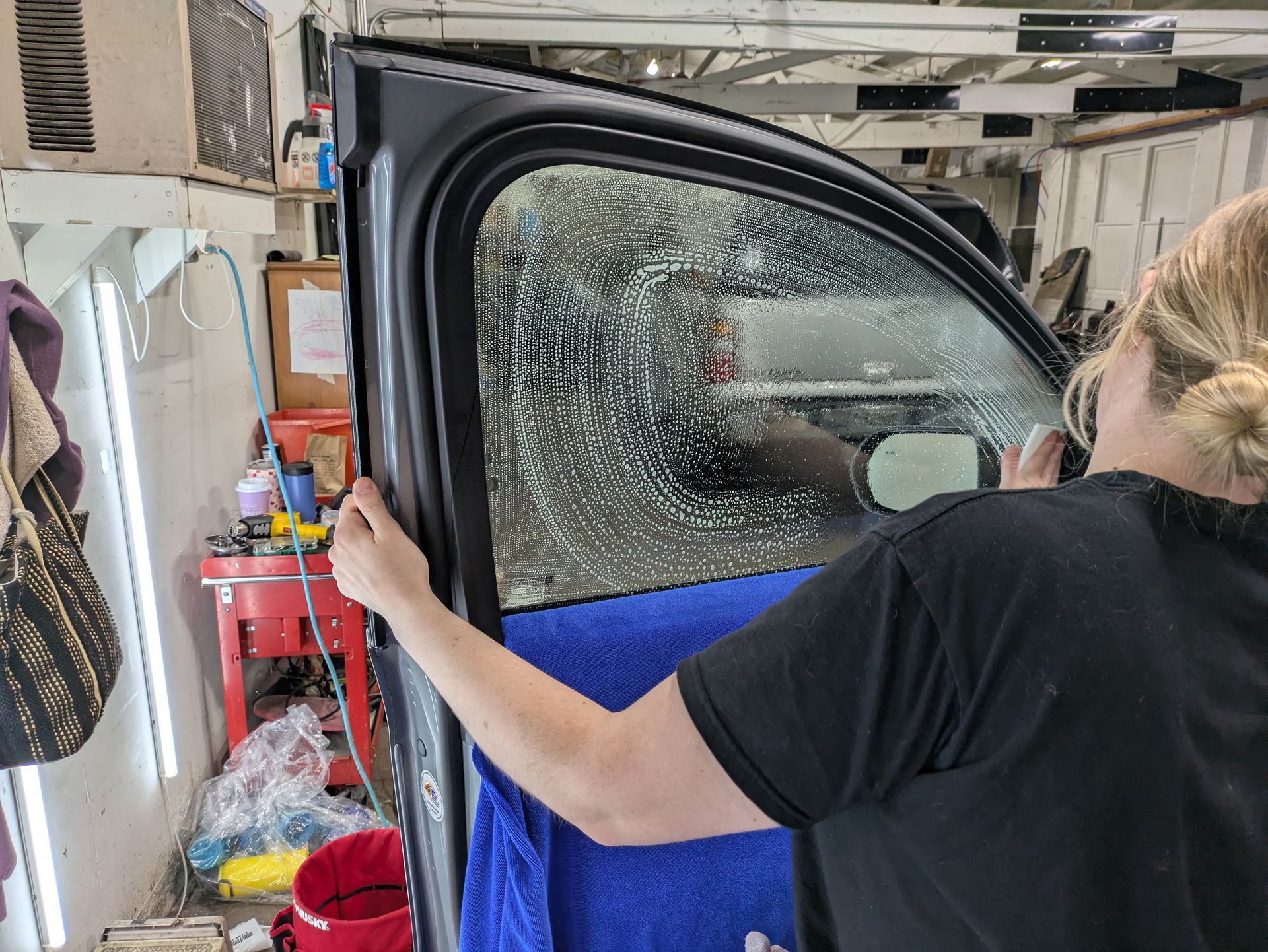Window tint installation in progress at Tidy Car in Sheboygan, Wisconsin