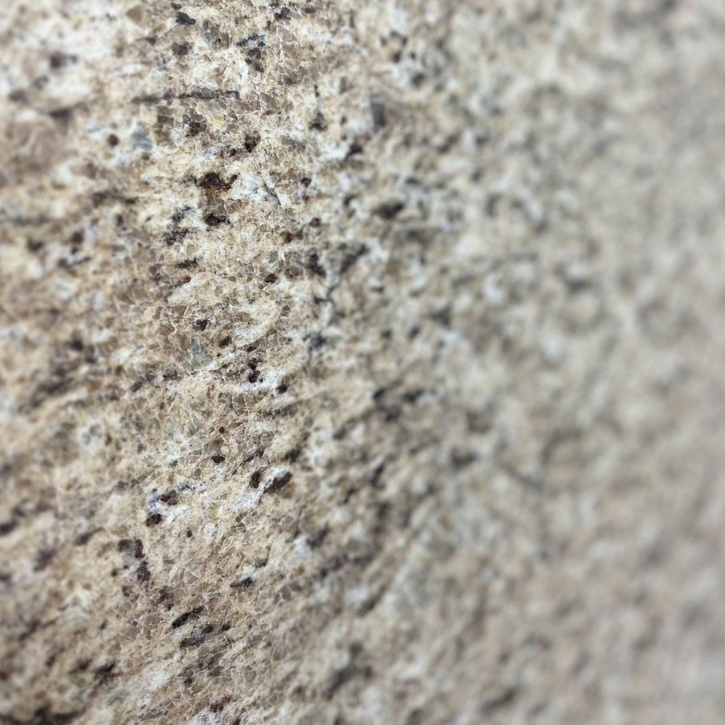 A close up of a granite counter top with a grainy texture.