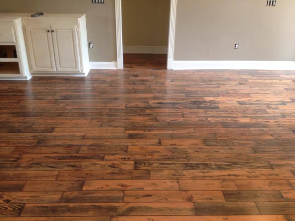 A living room with hardwood floors and white cabinets.