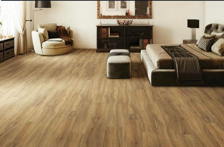 A bedroom with hardwood floors and a large bed