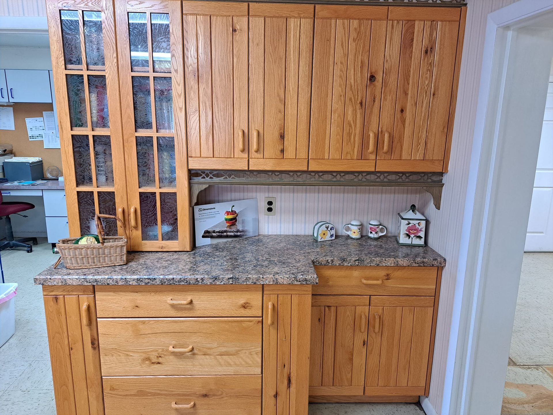 A kitchen with wooden cabinets and granite counter tops
