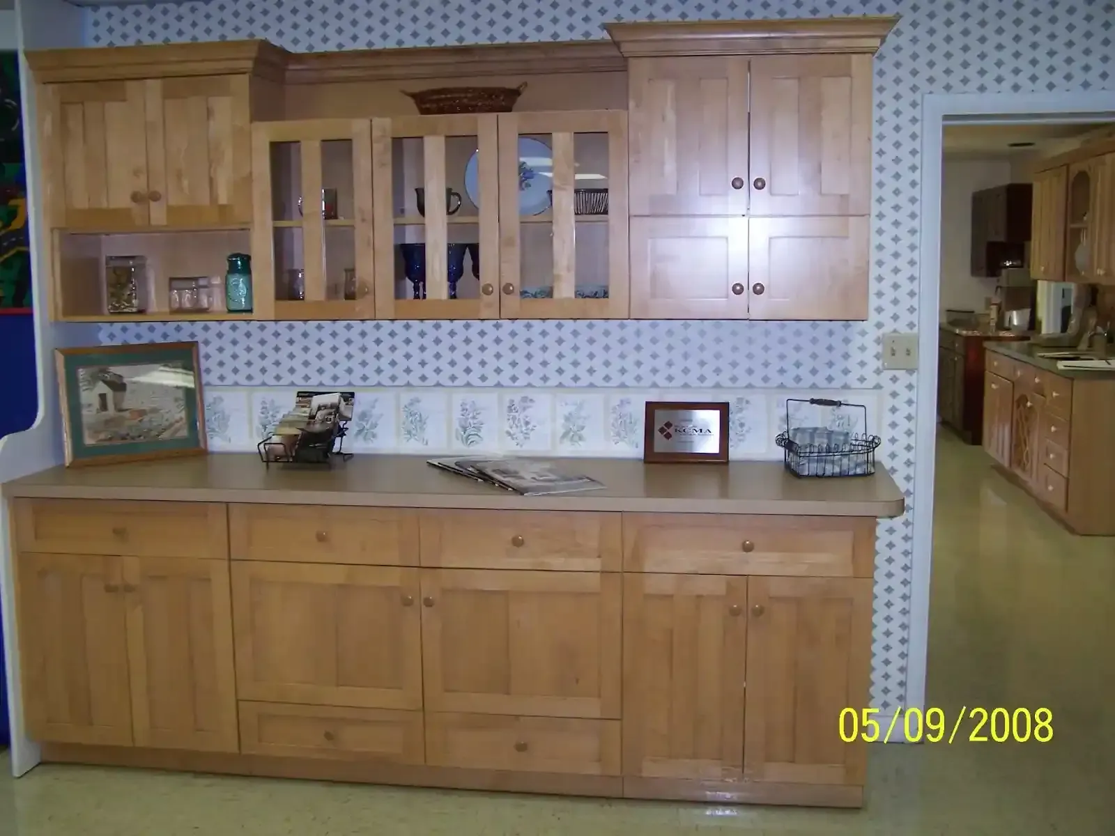 A kitchen with wooden cabinets and a large island