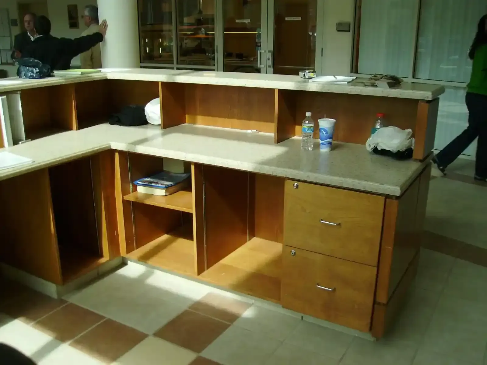 A kitchen with wooden cabinets and a rug on the floor