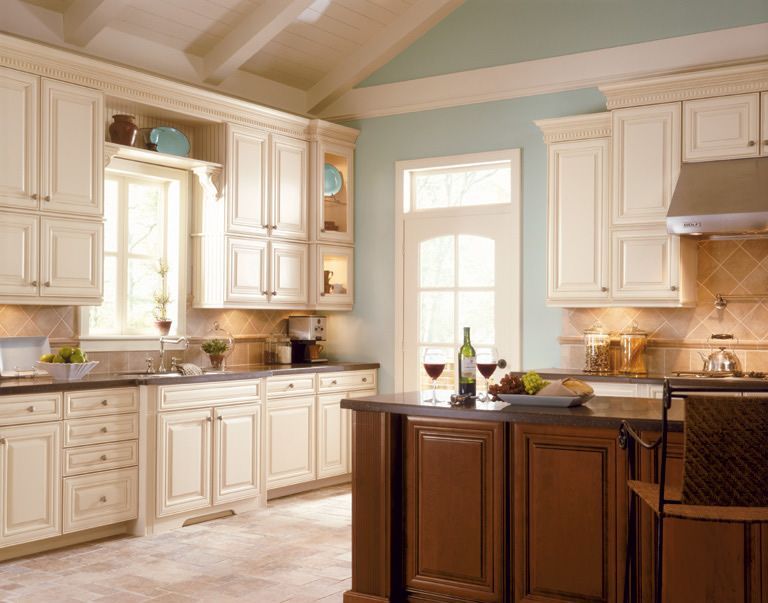 A kitchen with white cabinets and a large island