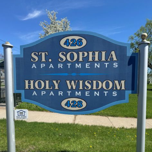 Blue sign for St. Sophia Apartments and Holy Wisdom Apartments with building numbers 426 and 428.