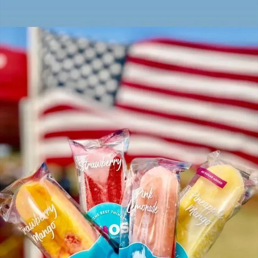 Colorful popsicles in front of a blurred American flag backdrop
