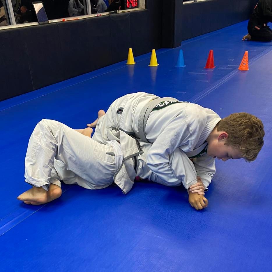 a boy wearing a karate uniform with the word karate on it
