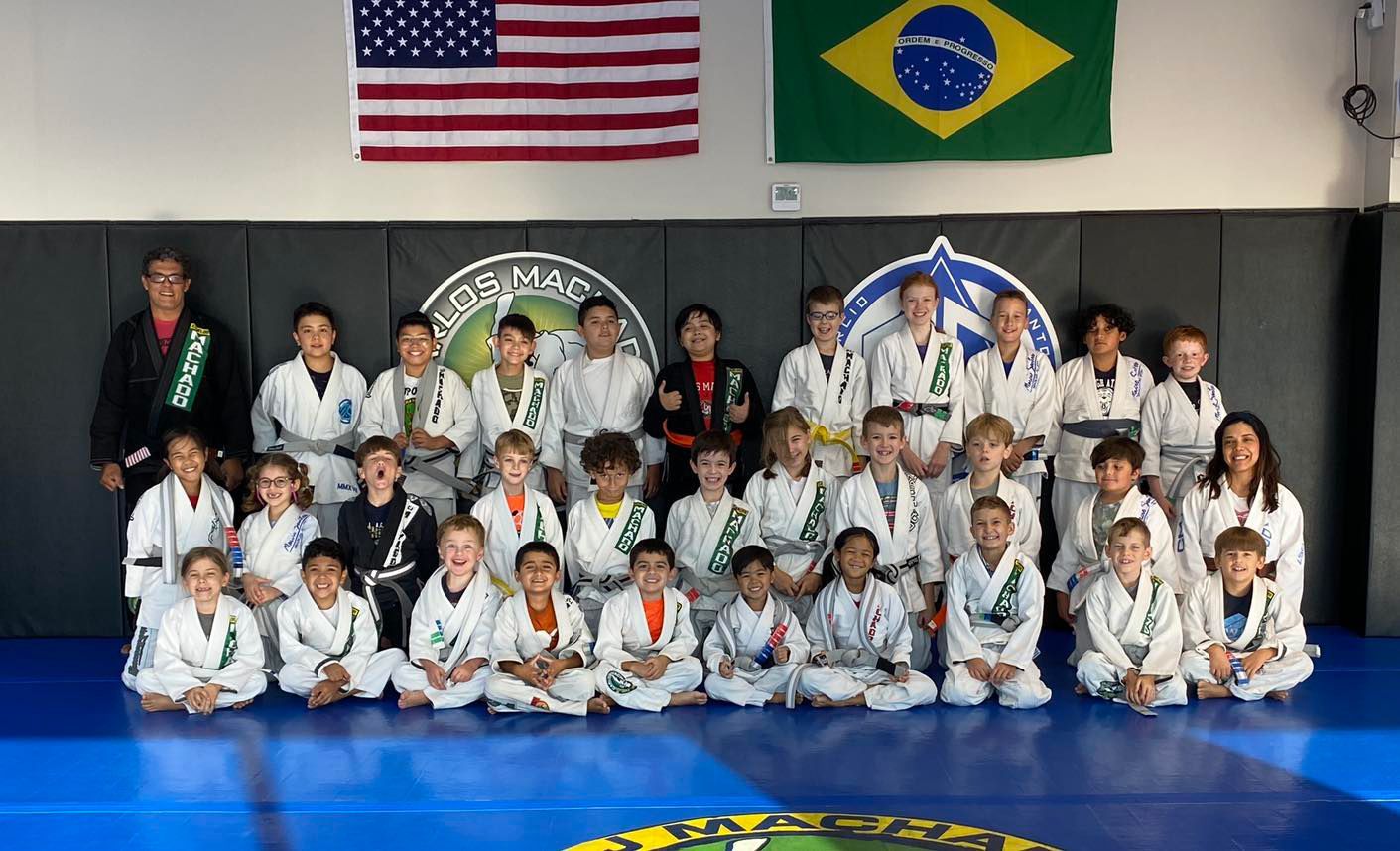 a group of kids are posing for a picture in a gym .