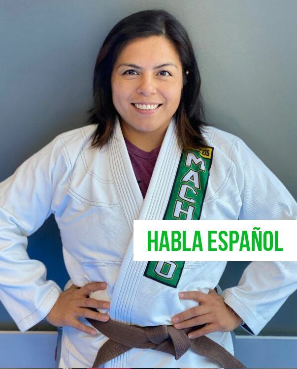 a woman wearing a white karate uniform with the word machado on it