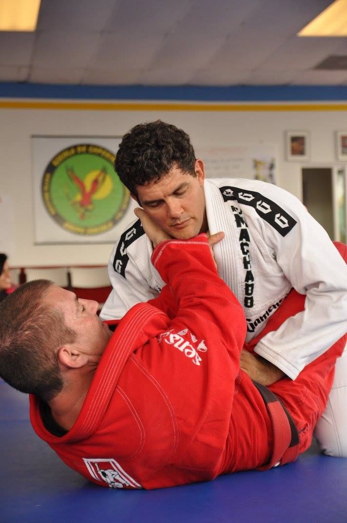 a man is laying on top of another man on a mat
