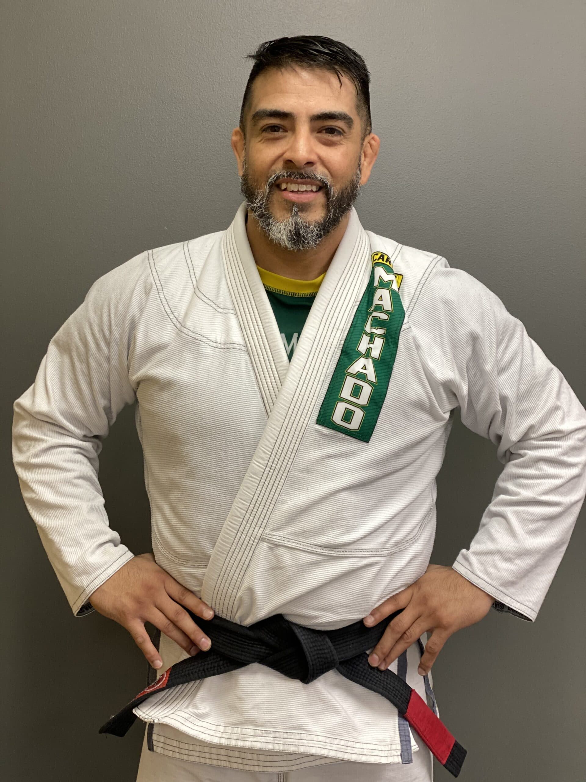 a man in a white karate uniform with a black belt