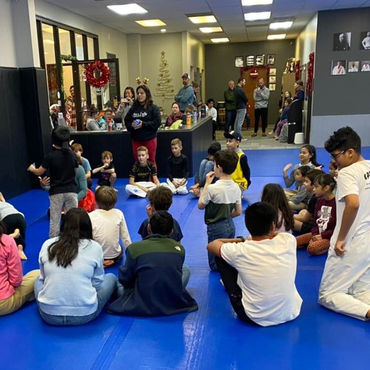 a group of children are playing with a hula hoop .