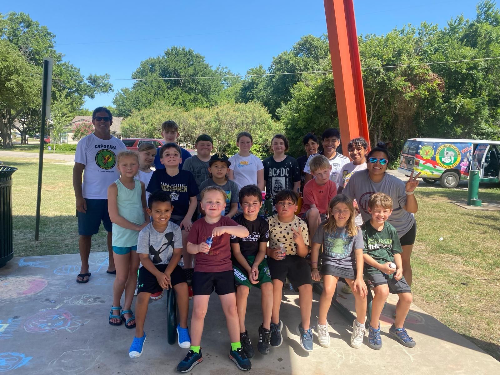 a group of children are posing for a picture on a playground.