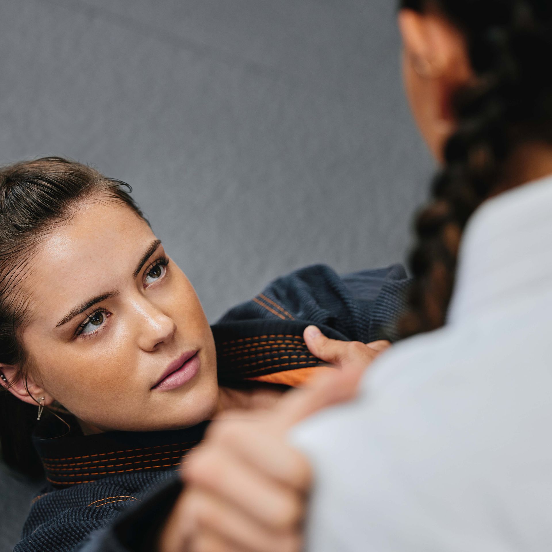 a woman is looking at another woman in a mirror .
