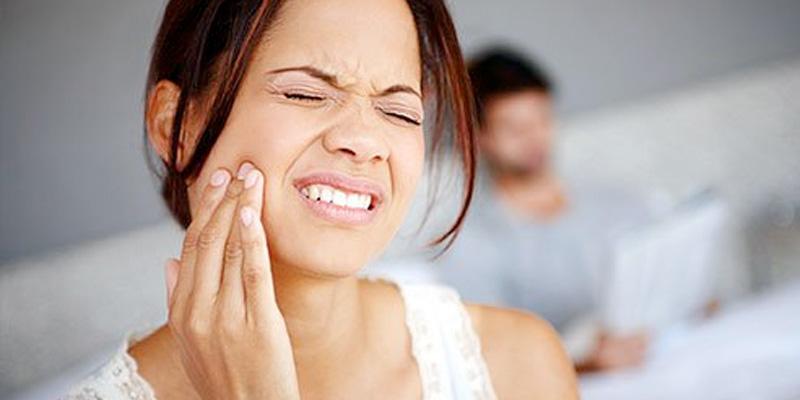 Dentist in Chester, VA: Woman in need of emergency dental care, which our dentist office provides
