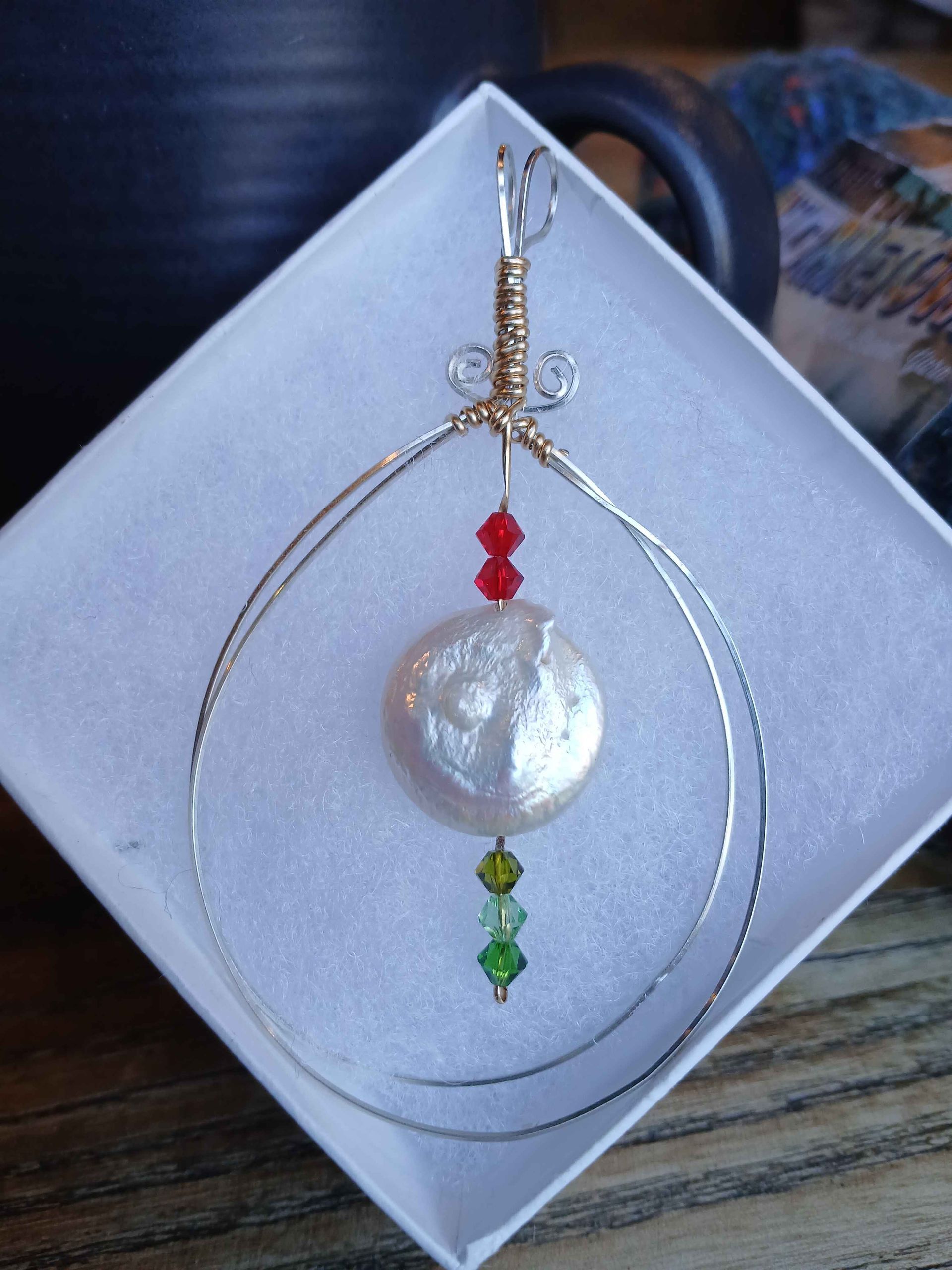 A white box with a necklace in it