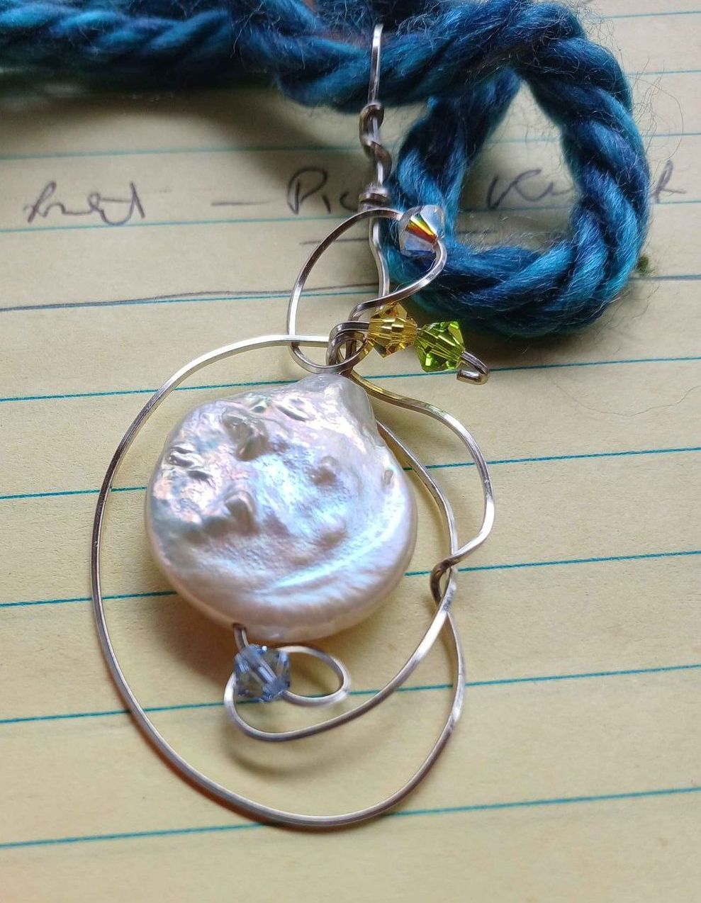 A close up of a pearl necklace on a piece of paper