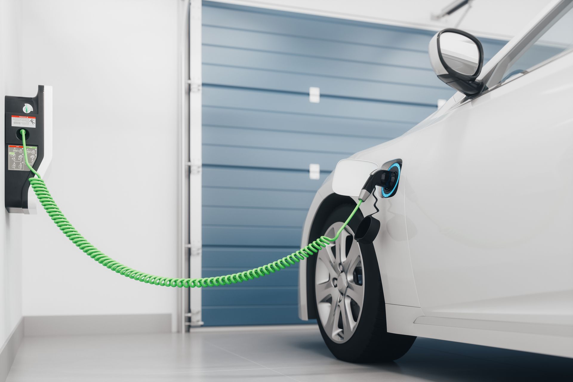 A white electric car is being charged in a garage.