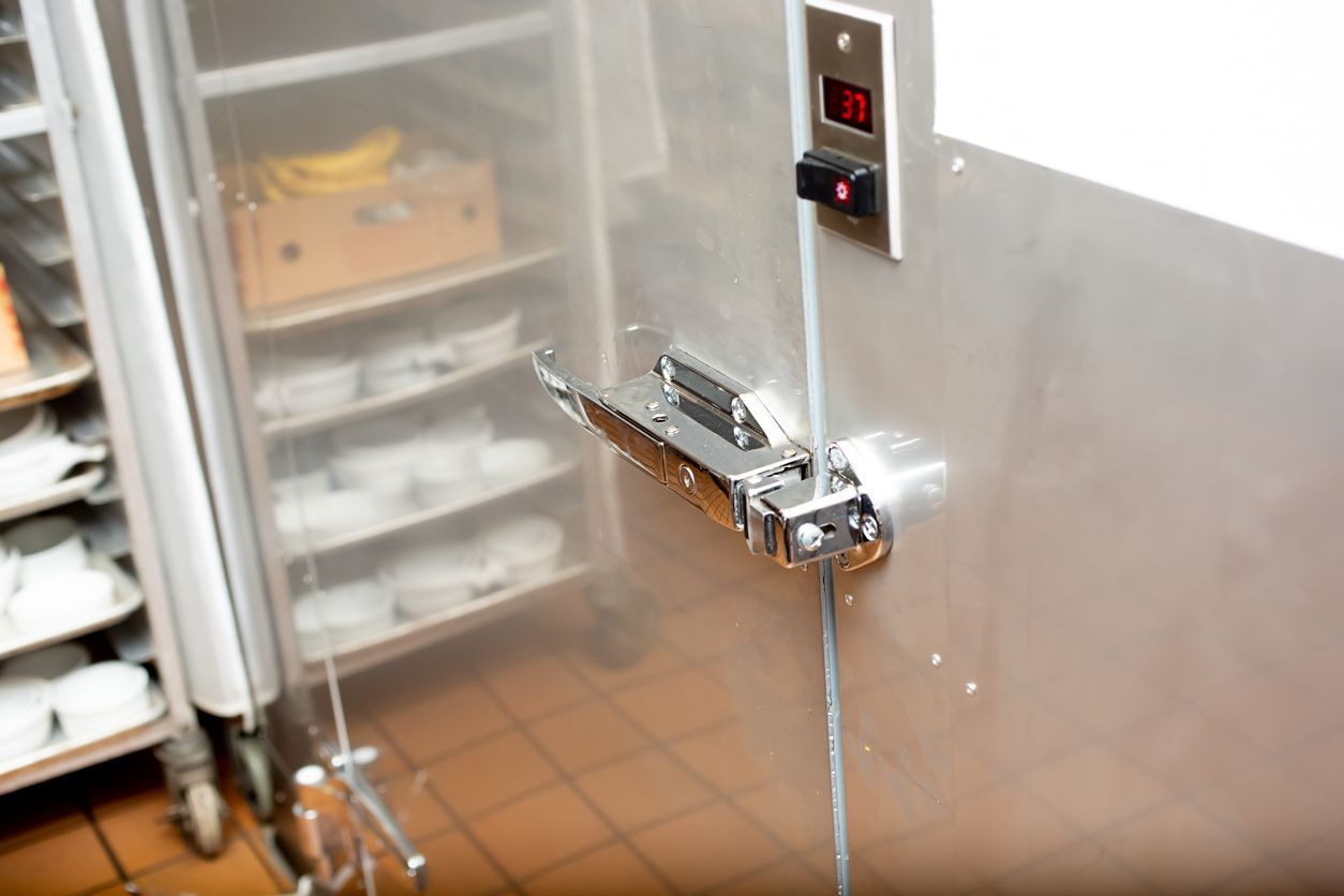 A stainless steel refrigerator in a kitchen with a digital display on the door.